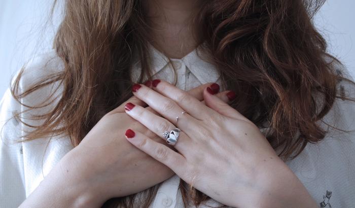 Woman holding hands in front of heart