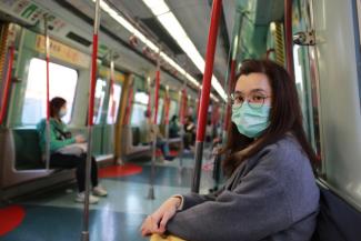 Asian girl in metro wearing face mask