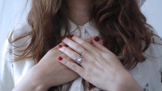 Woman holding hands in front of heart